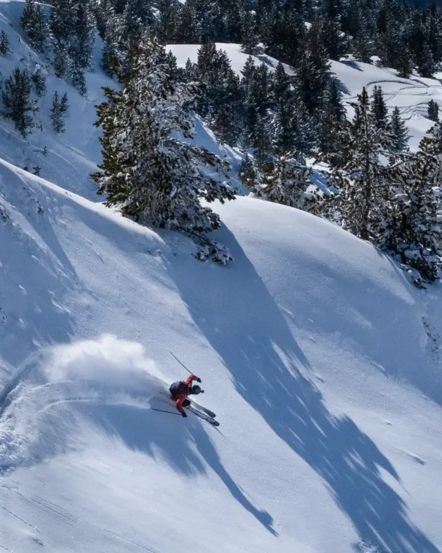 Skier making a powder turn on a steep slope in Val d'Aran